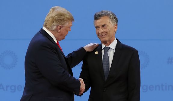 Argentina&#39;s President Mauricio Macri, right, welcomes President Donald Trump to the start of the G20 Leader&#39;s Summit at the Costa Salguero Center in Buenos Aires, Argentina, Friday, Nov. 30, 2018. (AP Photo/Ricardo Mazalan)