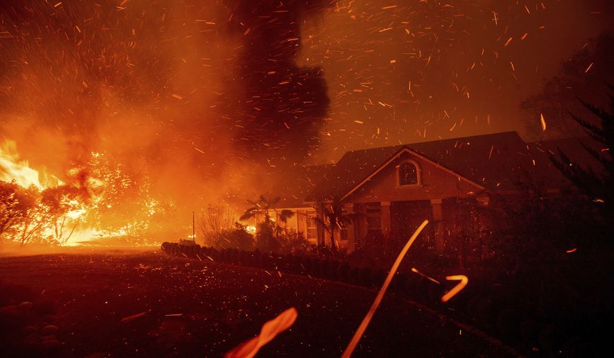 n this Thursday, Nov. 8, 2018, photo, the Camp Fire rages through Paradise, Calif. U.S. Interior Secretary Ryan Zinke says wildfires in California in 2018, released roughly the same amount of carbon emissions as are produced each year to provide electricity to the state. (AP Photo/Noah Berger) **FILE**