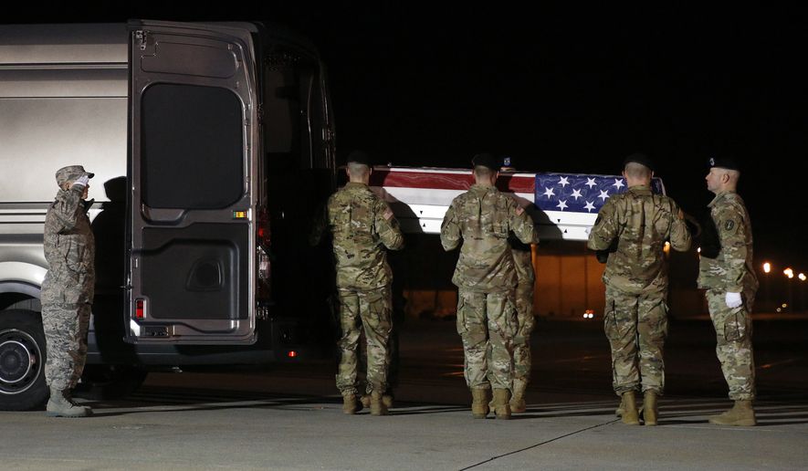 A U.S. Army carry team prepares to place a transfer case containing the remains of Capt. Andrew P. Ross into a vehicle, Friday, Nov. 30, 2018, at Dover Air Force Base, Del. According to the Department of Defense, Ross, 29, of Lexington, Va., was killed Nov. 27, 2018, by a roadside bomb in Andar, Ghazni Province, Afghanistan. (AP Photo/Patrick Semansky)