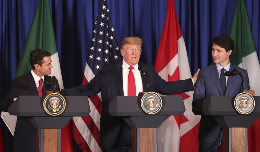President Donald Trump, center, reaches out to Mexico&#39;s President Enrique Pena Nieto, left, and Canada&#39;s Prime Minister Justin Trudeau as they prepare to sign a new United States-Mexico-Canada Agreement that is replacing the NAFTA trade deal, during a ceremony at a hotel before the start of the G20 summit in Buenos Aires, Argentina, Friday, Nov. 30, 2018. The USMCA, as Trump refers to it, must still be approved by lawmakers in all three countries. (AP Photo/Martin Mejia) **FILE**