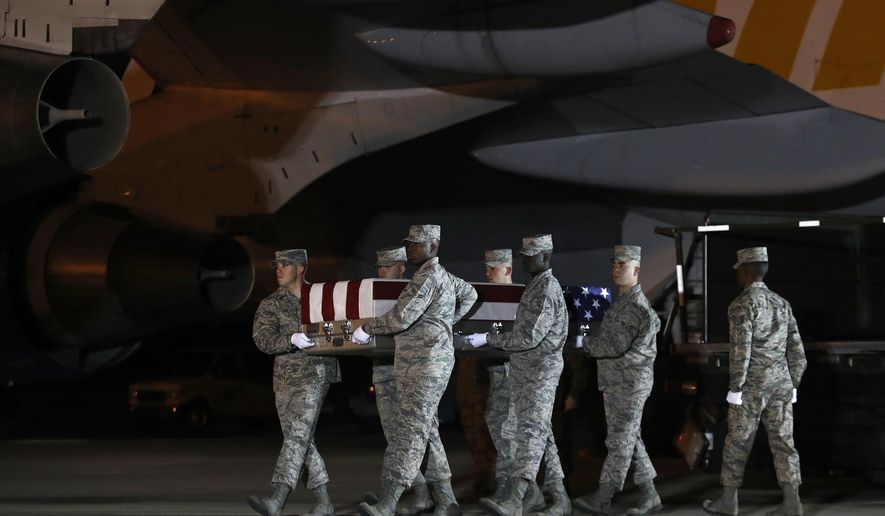 A U.S. Air Force carry team moves a transfer case containing the remains of Staff Sgt. Dylan J. Elchin, Friday, Nov. 30, 2018, at Dover Air Force Base, Del. According to the Department of Defense, Elchin, 25, of Hookstown, Pa., was killed Nov. 27, 2018, by a roadside bomb in Andar, Ghazni Province, Afghanistan. (AP Photo/Patrick Semansky)