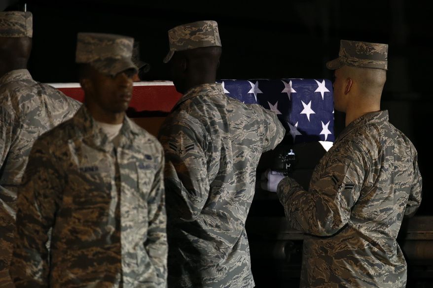 In this file photo, A U.S. Air Force carry team moves a transfer case containing the remains of Staff Sgt. Dylan J. Elchin, Friday, Nov. 30, 2018, at Dover Air Force Base, Del. According to the Department of Defense, Elchin, 25, of Hookstown, Pa., was killed Nov. 27, 2018, by a roadside bomb in Andar, Ghazni Province, Afghanistan. (AP Photo/Patrick Semansky)