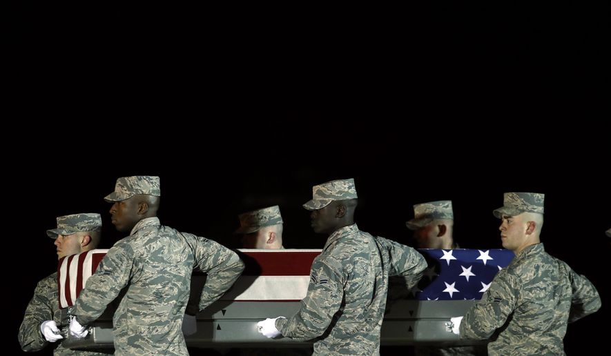 A U.S. Air Force carry team moves a transfer case containing the remains of Staff Sgt. Dylan J. Elchin, Friday, Nov. 30, 2018, at Dover Air Force Base, Del. According to the Department of Defense, Elchin, 25, of Hookstown, Pa., was killed Nov. 27, 2018, by a roadside bomb in Andar, Ghazni Province, Afghanistan. (AP Photo/Patrick Semansky)