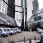 Police cars stand in the backyard of Deutsche Bank headquarters during a raid in Frankfurt, Germany, Thursday, Nov. 29, 2018. (AP Photo/Michael Probst)