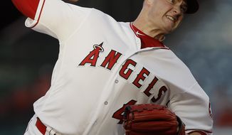 FILE - In this July 10, 2018, file photo, Los Angeles Angels starting pitcher Garrett Richards delivers to a Seattle Mariners batter during the first inning of a baseball game in Anaheim, Calif. Richards says on Twitter that he’s joining the rebuilding San Diego Padres. Multiple reports indicate the right-hander has agreed to a $15 million, two-year contract. Richards had reconstructive elbow surgery in July while with the Los Angeles Angels. Neither the Padres nor Richards’ agency would confirm the deal Thursday night, Nov. 29. AP Photo/Alex Gallardo, File)