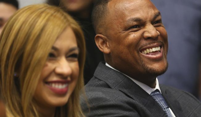 Adrian Beltre laughs with his wife Sandra before being introduced in Arlington, Texas, Friday, Nov. 30, 2018. Beltre, who spent the last eight seasons of his Hall of Fame-caliber career with the Texas Rangers, formally said goodbye in a laugh-filled news conference at the ballpark where the four-time All-Star and five-time Gold Glove third baseman joined the 3,000-hit club in 2017.  (AP Photo/Richard W. Rodriguez)