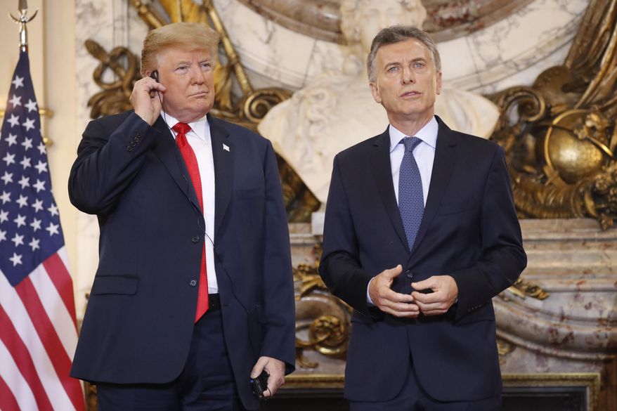 President Donald Trump listens to the translation as Argentina's President Mauricio Macri speaks during their meeting at Casa Rosada, Friday, Nov. 30, 2018 in Buenos Aires, Argentina. (AP Photo/Pablo Martinez Monsivais)