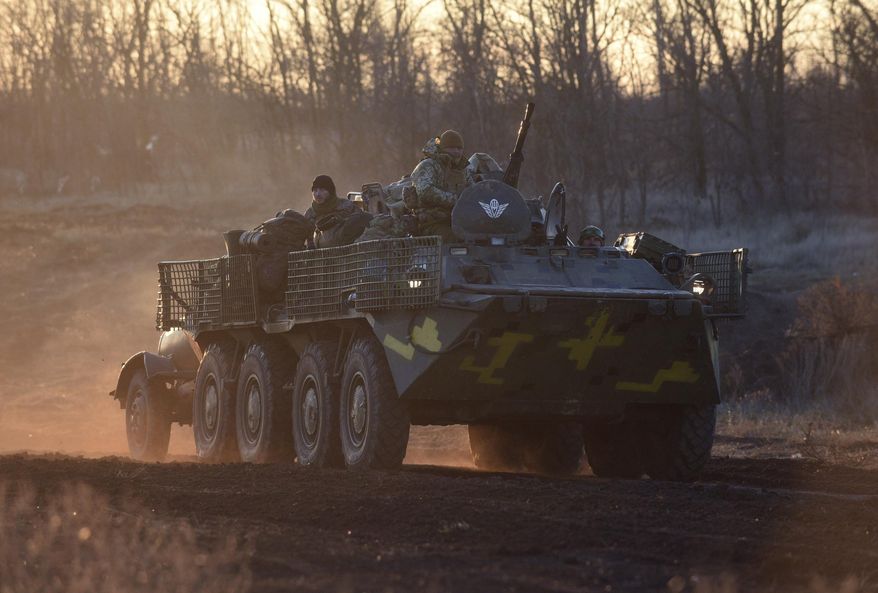 Ukrainian soldiers drive APCs near Urzuf, south coast of Azov sea, eastern Ukraine, Thursday, Nov. 29, 2018. Ukraine put its military forces on high combat alert and announced martial law this week after Russian border guards fired on and seized three Ukrainian ships in the Black Sea. (AP Photo/Evgeniy Maloletka)