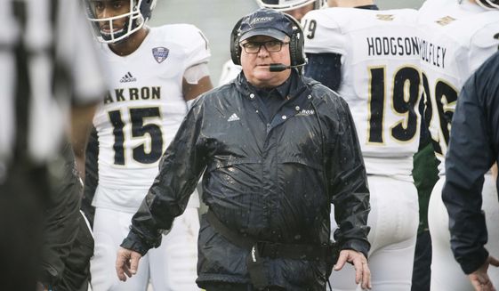 Akron head coach Terry Bowden walks back to the sideline after a timeout during the first half of an NCAA college football game Saturday, Dec. 1, 2018, in Columbia, S.C. South Carolina defeated Akron 28-3. (AP Photo/Sean Rayford)