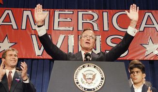 FILE - In this Nov. 9, 1988 file photo, President-elect George H. W. Bush holds his hands up to acknowledge the crowds applause, and ask them to allow him to continue his speech, during his victory rally with grandson, George P. Bush, right, and son George W. Bush, left, in Houston, Texas.  The Kennedys had their New England coastal hideaway in Hyannis Port, a Camelot-like mystique and a political godfather in Joseph P. Kennedy. For the country&#39;s other political dynasty, the Bushes ,  it was a summer home in Maine and the West Texas oil patch that created a mix of Yale blue-blood and backcountry cowboy. Their patriarch was George H.W. Bush, a World War II hero, Texas congressman, the director of the CIA, vice president and eventually president.  (AP Photo, File)