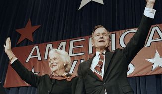 FILE - In this Nov. 8, 1988 file photo, President-elect George H.W. Bush and his wife Barbara wave to supporters in Houston, Texas after winning the presidential election. Bush has died at age 94. Family spokesman Jim McGrath says Bush died shortly after 10 p.m. Friday, Nov. 30, 2018, about eight months after the death of his wife, Barbara Bush. (AP Photo/Scott Applewhite, File)