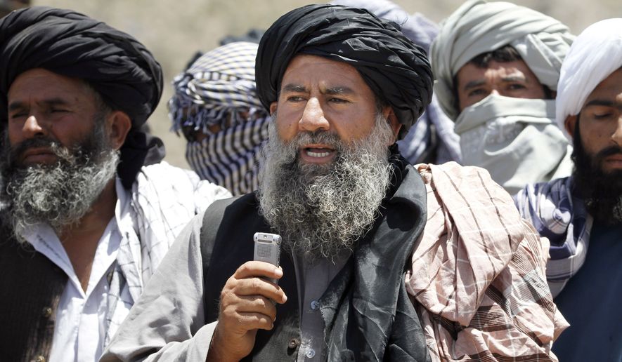 Senior leader of a breakaway faction of the Taliban Mullah Abdul Manan Niazi, center, delivers a speech to his fighters, in Shindand district of Herat province, Afghanistan, in this Friday, May 27, 2016 file photo. Niazi said Sunday, May 29, 2016 it was willing to hold peace talks with the Afghan government but would demand the imposition of Islamic law and the departure of all foreign forces. (AP Photos/Allauddin Khan) ** FILE **