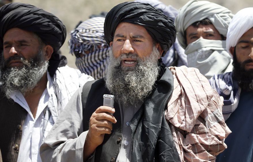 Senior leader of a breakaway faction of the Taliban Mullah Abdul Manan Niazi, center, delivers a speech to his fighters, in Shindand district of Herat province, Afghanistan, in this Friday, May 27, 2016 file photo. Niazi said Sunday, May 29, 2016 it was willing to hold peace talks with the Afghan government but would demand the imposition of Islamic law and the departure of all foreign forces. (AP Photos/Allauddin Khan) ** FILE **
