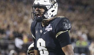 UCF quarterback Darriel Mack Jr. celebrates after he scored a fourth quarter touchdown during an NCAA college football game in the AAC Championship in Orlando on Saturday, Dec. 1, 2018. UCF won the game to claim the AAC Championship. (Stephen M. Dowell/Orlando Sentinel via AP)