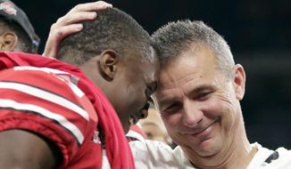 Ohio State head coach Urban Meyer and wide receiver Terry McLaurin, left, celebrate early Sunday, Dec. 2, 2018, after defeating Northwestern 45-24 in the Big Ten championship NCAA college football game in Indianapolis. (AP Photo/Michael Conroy)