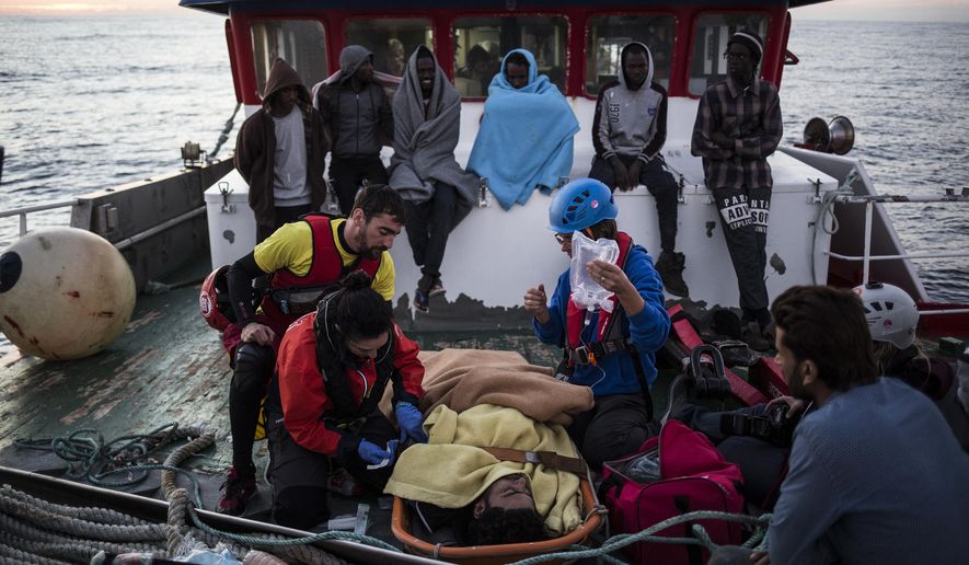 In this Friday, Nov. 30, 2018, photo, a migrant is prepared to be evacuated for medical reasons by helicopter from the Nuestra Madre de Loreto Spanish fishing vessel carrying 12 migrants rescued off the coast of Lybia. (AP Photo/Javier Fergo)