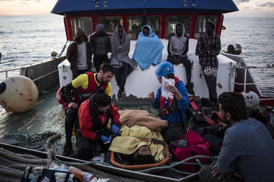In this Friday, Nov. 30, 2018, photo, a migrant is prepared to be evacuated for medical reasons by helicopter from the Nuestra Madre de Loreto Spanish fishing vessel carrying 12 migrants rescued off the coast of Lybia. (AP Photo/Javier Fergo)