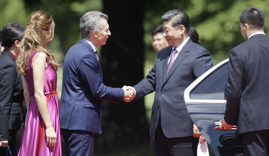 Argentina&#39;s President Mauricio Macri and first lady Juliana Awada welcome China&#39;s President Xi Jinping at presidential residence in Olivos, a northern suburb of Buenos Aires, Argentina, Sunday, Dec. 2, 2018. (AP Photo/Martin Mejia)