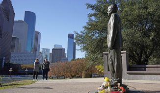 Deitz Kracker, left, and Marg Frazier visit a statue of former President George H.W. Bush in downtown Houston, Sunday, Dec. 2, 2018. Bush is returning to Washington as a revered political statesman, hailed by leaders across the political spectrum and around the world as a man not only of greatness but also of uncommon decency and kindness.  Bush, died late Friday at his Houston home at age 94, is to be honored with a state funeral at National Cathedral in the nation&#39;s capital on Wednesday, followed by burial Thursday on the grounds of his presidential library at Texas A&amp;amp;M.(AP Photo/David J. Phillip)