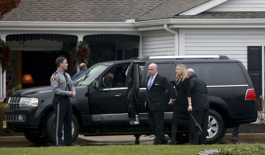 A hearse is parked oiuuside funeral services at the Holmdel Funeral Home in Holmdel, N.J., to mourn Keith Caneiro; his wife, Jennifer, and their two young children, Jesse and Sophia. All were found dead Nov. 20 at their Colts Neck mansion. (Ed Murray/NJ Advance Media via AP)
