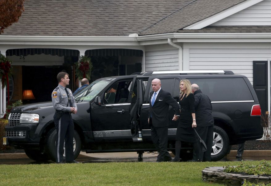 A hearse is parked oiuuside funeral services at the Holmdel Funeral Home in Holmdel, N.J., to mourn Keith Caneiro; his wife, Jennifer, and their two young children, Jesse and Sophia. All were found dead Nov. 20 at their Colts Neck mansion. (Ed Murray/NJ Advance Media via AP)