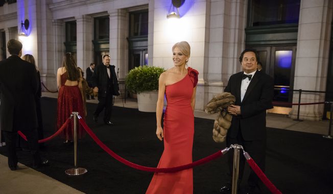 In this Thursday, Jan. 19, 2017, file photo, President-elect Donald Trump adviser Kellyanne Conway, center, accompanied by her husband, George, speaks with members of the media as they arrive for a dinner at Union Station in Washington, the day before Trump&#x27;s inauguration. (AP Photo/Matt Rourke) ** FILE **