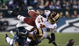 Philadelphia Eagles&#x27; Golden Tate, left, cannot hang onto a pass against Washington Redskins&#x27; Zach Brown, center, and Mason Foster during the first half of an NFL football game, Monday, Dec. 3, 2018, in Philadelphia. (AP Photo/Michael Perez) **FILE**