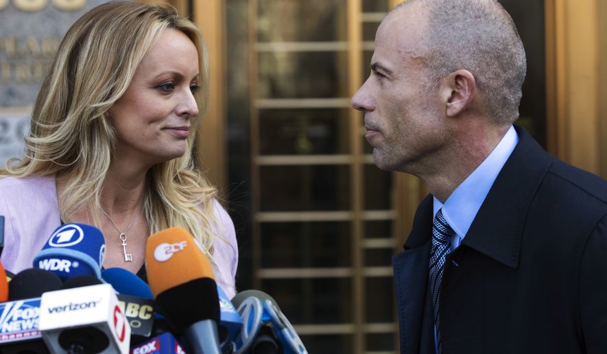 Adult film actress Stormy Daniels, left, stands with her lawyer, Michael Avenatti, after speaking outside federal court in New York on April 16, 2018. (AP Photo/Mary Altaffer)