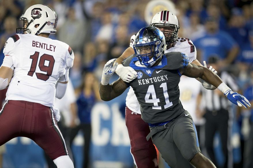 FILE - In this Sept. 29, 2018, file photo, Kentucky linebacker Josh Allen (41) rushes South Carolina quarterback Jake Bentley (19) during the second half of an NCAA college football game in Lexington, Ky. Allen is the defensive player of the year on The Associated Press All-Southeastern Conference team, announced Monday, Dec. 3, 2018. (AP Photo/Bryan Woolston, File)
