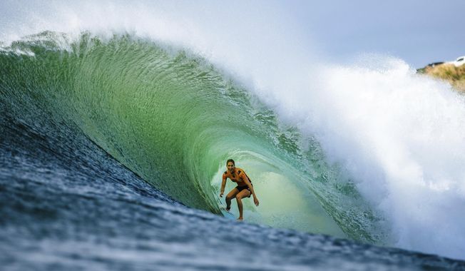 In this 2018 photo, Stephanie Gilmore of Australia competes at the Beachwaver Maui Pro, in Honolua, Hawaii. If Gilmore wins the gold medal when surfing makes its Olympic debut next year, it might be considered a very nice bonus. Now in the conversation as the greatest of all time on the women’s side in her sport, Gilmore successfully fought for another prize, equal pay for the women, on the professional tour where she and the rest of her rivals make their living. (Ed Sloane/World Surf League via AP)