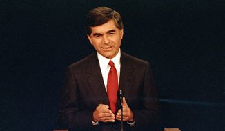 FILE - In this Sept. 25, 1988 file photo, Massachusetts Democratic Governor Michael Dukakis makes a point during the first presidential debate with his opponent U.S. Vice President George Bush in Winston-Salem, N.C. Dukakis, who lost to George H.R. Bush in the 1988 presidential election, said Saturday, Dec. 1, 2018 that his former political foe’s legacy was his effort to help end the Cold War.  “Obviously we disagreed pretty strongly on domestic policy and I wasn’t thrilled with the kind of campaign he ran, but I think his greatest contribution was in negotiating the end of the Cold War with (Soviet leader) Mikhail Gorbachev,” Dukakis told The Associated Press in a telephone interview. (AP Photo/Bob Jordan, File)
