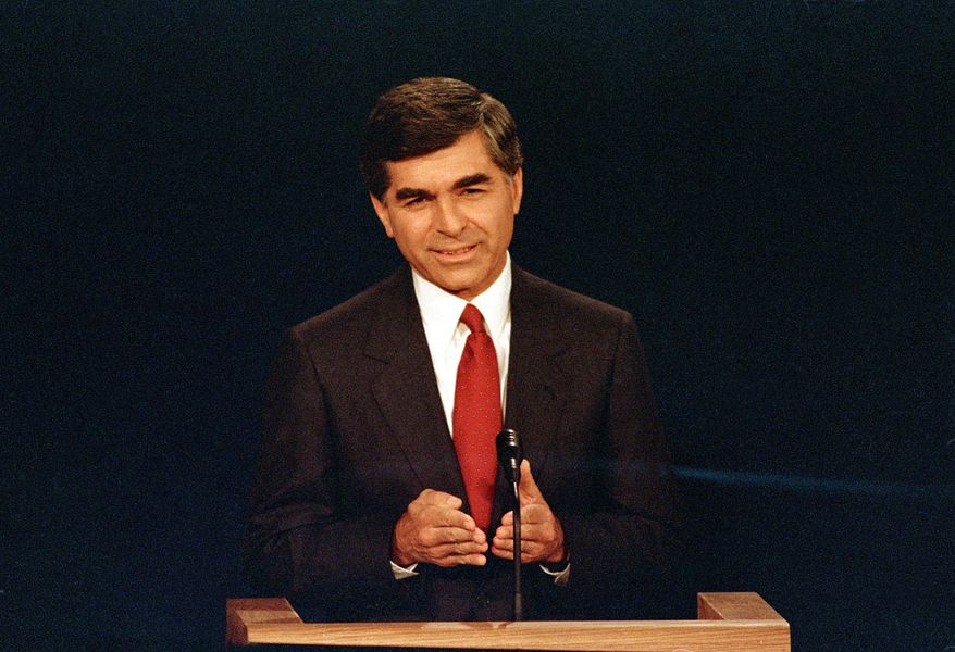 FILE - In this Sept. 25, 1988 file photo, Massachusetts Democratic Governor Michael Dukakis makes a point during the first presidential debate with his opponent U.S. Vice President George Bush in Winston-Salem, N.C. Dukakis, who lost to George H.R. Bush in the 1988 presidential election, said Saturday, Dec. 1, 2018 that his former political foe’s legacy was his effort to help end the Cold War.  “Obviously we disagreed pretty strongly on domestic policy and I wasn’t thrilled with the kind of campaign he ran, but I think his greatest contribution was in negotiating the end of the Cold War with (Soviet leader) Mikhail Gorbachev,” Dukakis told The Associated Press in a telephone interview. (AP Photo/Bob Jordan, File)
