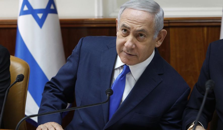 Israeli Prime Minister Benjamin Netanyahu attends the weekly cabinet meeting at his office in Jerusalem, Sunday Dec. 2, 2018. Israeli police on Sunday recommended indicting Prime Minister Netanyahu on bribery charge allegations related to a corruption case involving Israel's Bezeq telecom giant. (Gali Tibbon/Pool via AP)