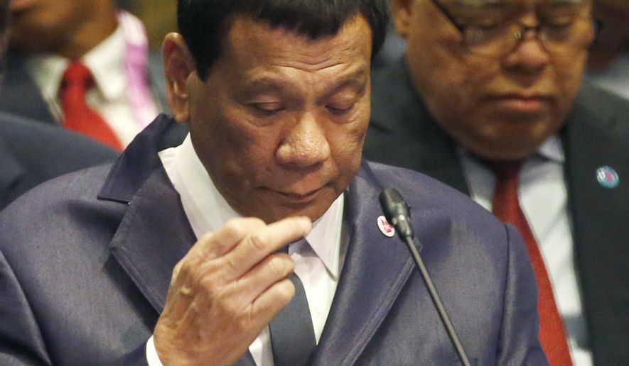 FILE - In this Nov. 14, 2018, file photo, Philippine President Rodrigo Duterte listens to a speech during a ASEAN Plus China Summit meeting in Singapore. Duterte, whose controversial war on drugs has cost thousands of lives, said Monday, Dec. 3, 2018, he uses marijuana to keep awake at long regional meetings, but later disavowed his assertion as a joke. Duterte made the comment at an awards ceremony where he talked about attending a recent summit meeting in Singapore of the Association of Southeast Asian Nations and how the daylong schedules of such gatherings is grueling. (AP Photo/Bullit Marquez, File)