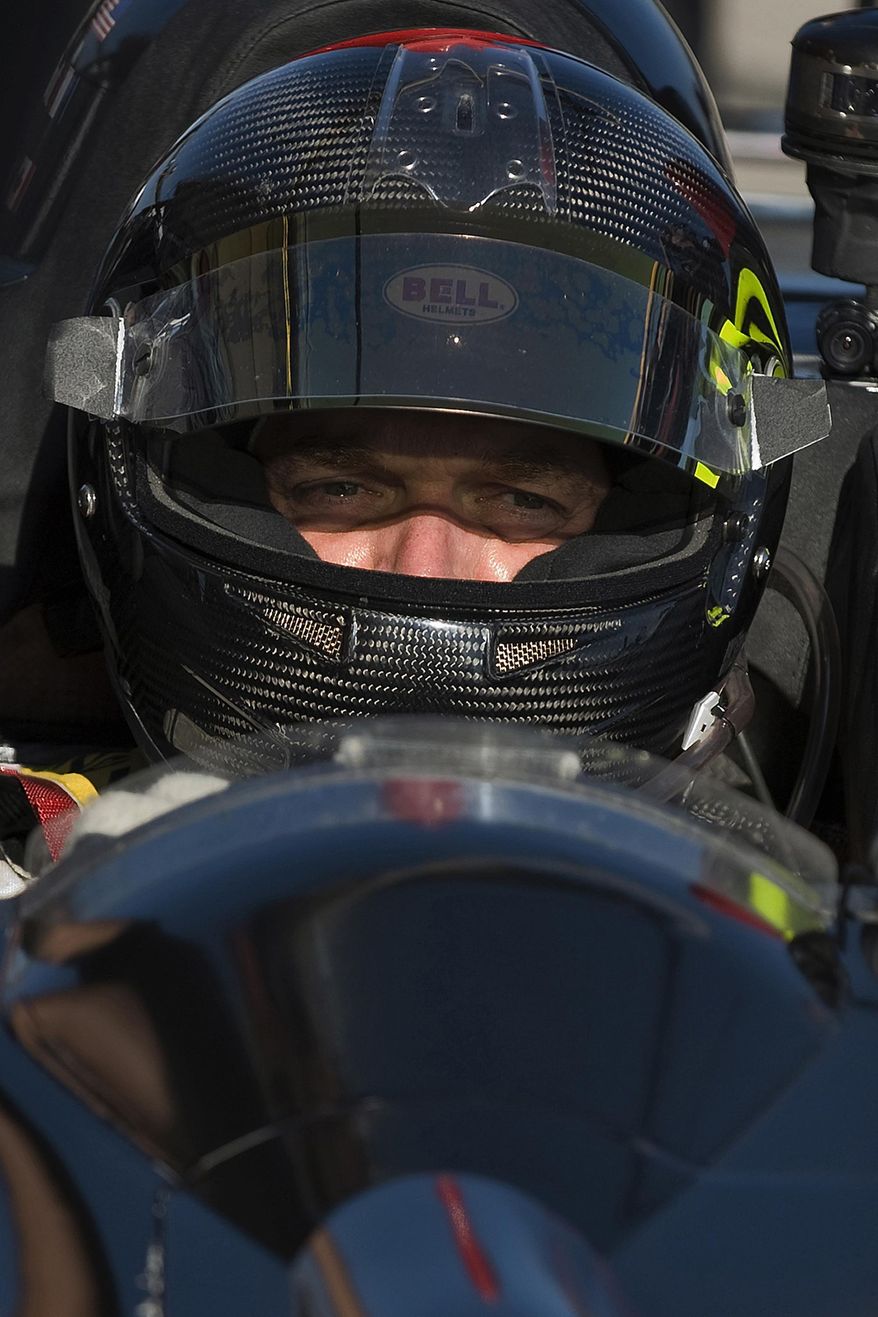 FILE- In this March 19, 2010, file photo, Level 5 Motorsports driver Scott Tucker waits during a break in a practice session for the American Le Mans Series' 12 Hours of Sebring auto race in Sebring, Fla. A U.S. appeals court has upheld a nearly $1.3 billion award against a pro racecar driver who ran a payday loan business accused by federal authorities of deceiving consumers. A unanimous three-judge panel of the 9th U.S. Circuit Court of Appeals ruled Monday, Dec. 3, 2018, that information Scott Tucker provided consumers did not accurately disclose the terms of the loans. The appeals panel also said a lower court did not abuse its authority when it ordered Tucker and other defendants to pay back nearly $1.3 billion. (AP Photo/Steve Nesius, File)