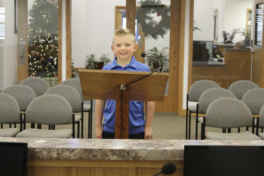 In this Thursday, Nov. 29, 2018, photograph, 9-year-old Dane Best poses in the council chambers in Severance, Colo. Dane is trying to get rid of his town's ban on snowballs and officials are wondering what took so long. (Sara Knuth/Greeley Tribune via AP)
