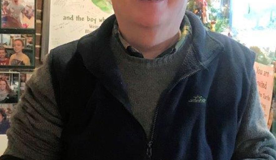 In this Dec. 1, 2018, photo provided by Brad Tonner, Diane the Turtle, wearing a party hat, celebrates her 50th birthday with her owner, Jim Tonner, at a gift shop he and his brother Brad run in Bristol, N.H. Diane the Turtle was given to Jim Tonner when he was 12 and being treated for hip arthritis at his home in Braintree, Mass. (Brad Tonner via AP)