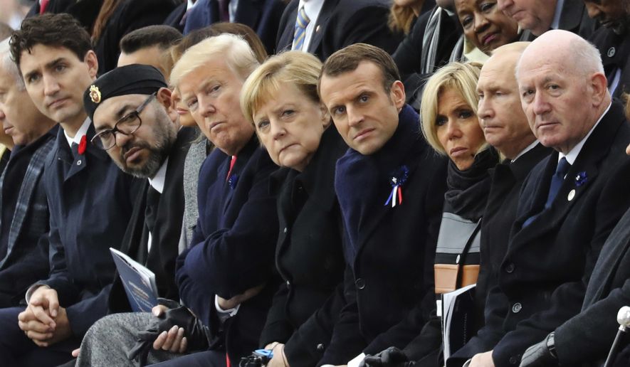 World leaders, from left, Canadian Prime Minister Justin Trudeau, Morocco's Prince Moulay Hassan, Moroccan King Mohammed VI, U.S. first lady Melania Trump, U.S. President Donald Trump, German Chancellor Angela Merkel, French President Emmanuel Macron and his wife Brigitte Macron, Russian President Vladimir Putin and Australian Governor-General Peter Cosgrove attend a ceremony at the Arc de Triomphe in Paris as part of the commemorations marking the 100th anniversary of the Nov. 11, 1918, armistice, which ended World War I, on Sunday, Nov. 11, 2018. (Ludovic Marin/Pool Photo via AP) **FILE**