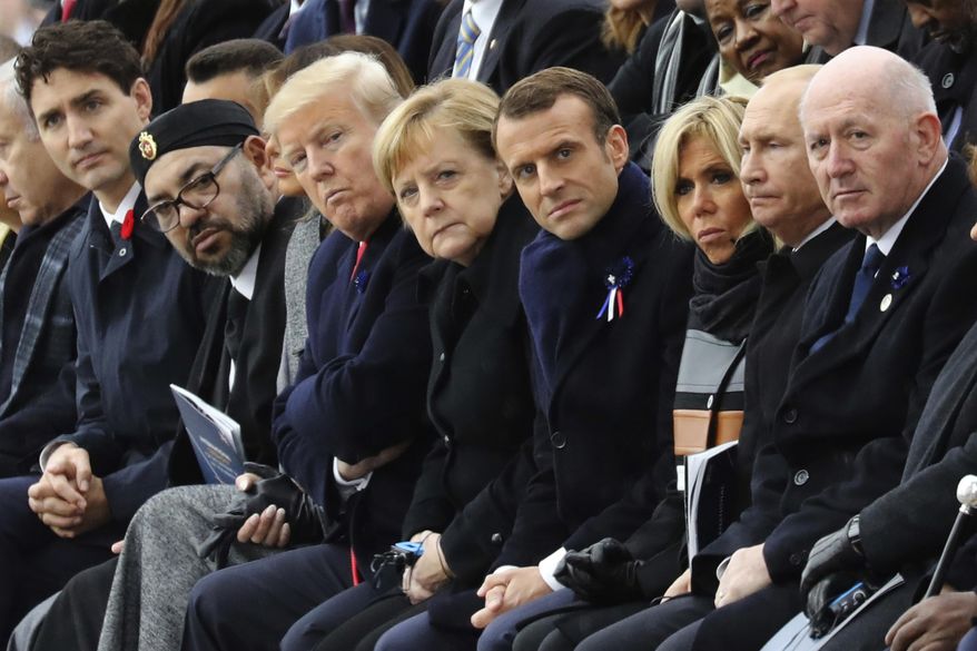World leaders, from left, Canadian Prime Minister Justin Trudeau, Morocco's Prince Moulay Hassan, Moroccan King Mohammed VI, U.S. first lady Melania Trump, U.S. President Donald Trump, German Chancellor Angela Merkel, French President Emmanuel Macron and his wife Brigitte Macron, Russian President Vladimir Putin and Australian Governor-General Peter Cosgrove attend a ceremony at the Arc de Triomphe in Paris as part of the commemorations marking the 100th anniversary of the Nov. 11, 1918, armistice, which ended World War I, on Sunday, Nov. 11, 2018. (Ludovic Marin/Pool Photo via AP) **FILE**