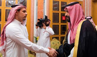 In this photo released by the Saudi Press Agency, Saudi Crown Prince Mohammed bin Salman, right, shakes hands with Salah Khashoggi, a son of Jamal Khashoggi, in Riyadh, Saudi Arabia, on Oct. 23, 2018. The meeting came just days after Saudi Arabia acknowledged that Jamal Khashoggi was killed at the Saudi consulate in Istanbul, Turkey, in what they claimed was a &amp;quot;fistfight.&amp;quot; (Saudi Press Agency via AP)