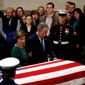 Former President George W. Bush and former first lady Laura Bush pause in front of the flag-draped casket of former President George H.W. Bush as he lies in state in the Capitol&#39;s Rotunda in Washington, Tuesday, Dec. 4, 2018. (AP Photo/Patrick Semansky)