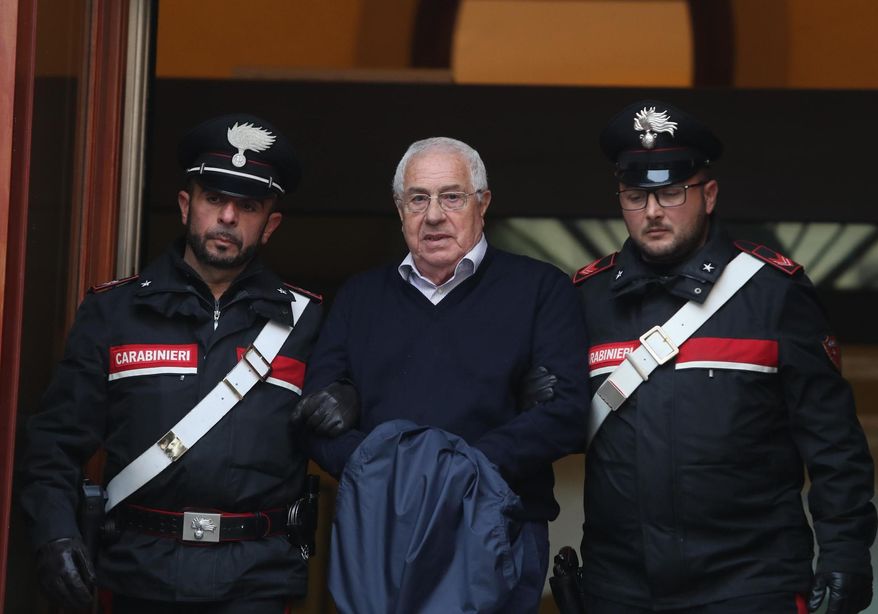 CORRECTS FIRST NAME TO SETTIMO, NOT SETTIMINO - Settimino Mineo, center, who allegedly took over as the Palermo head of Cosa Nostra, is escorted by Italian Carabinieri police after an anti Mafia operation which led the arrest of 46 people including the presumed regional boss, in Palermo, Sicily, Italy, Tuesday, Dec. 4, 2018. Italian police say they have dismantled the rebuilt upper echelons of the Sicilian Mafia. (Igor Petyx/ANSA via AP)