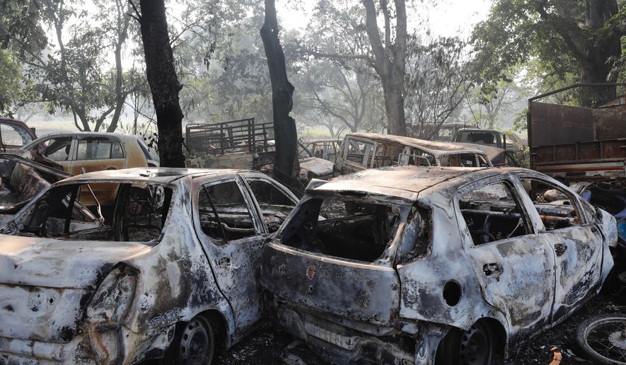 Cars lie vandalized near a police station after a mob attack in Chingarwathi, near Bulandshahr, in the northern Indian state of Uttar Pradesh, Tuesday, Dec. 4, 2018. Two people, including a police officer, were killed Monday in the mob violence that began with accusations of cow slaughter in the area. (AP Photo)
