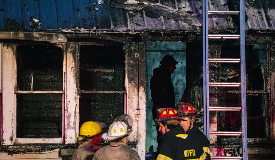 Firefighters work the scene of a fatal house fire in White Pigeon, Mich., on Tuesday, Dec. 4, 2018. (Joel Bissell/Kalamazoo Gazette via AP)