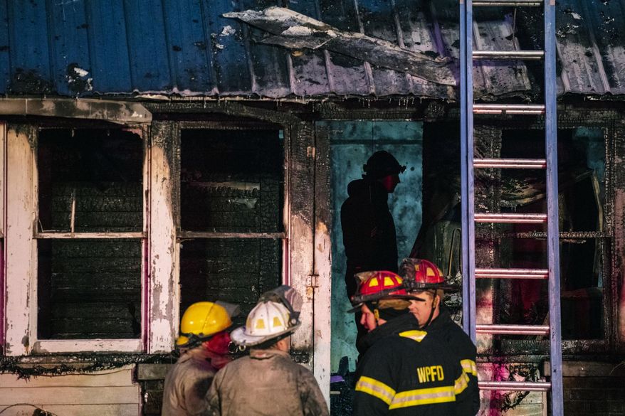 Firefighters work the scene of a fatal house fire in White Pigeon, Mich., on Tuesday, Dec. 4, 2018. (Joel Bissell/Kalamazoo Gazette via AP)