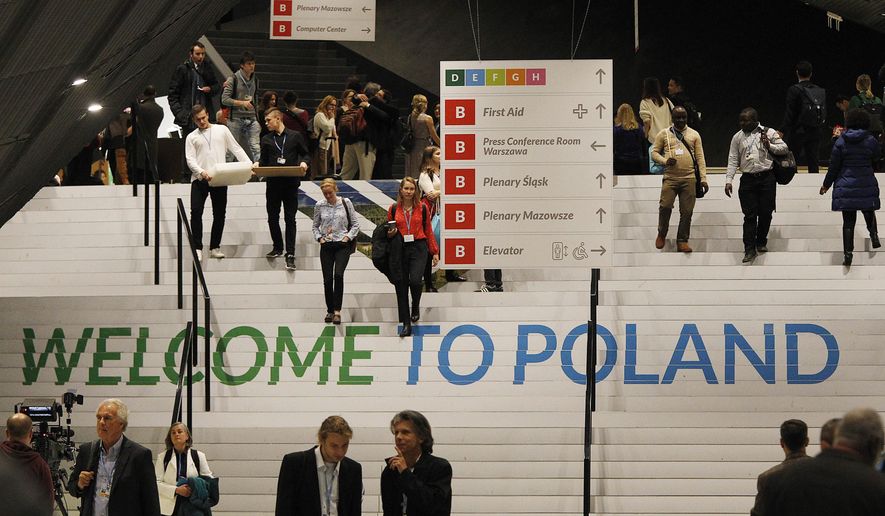 People walks down the stairs inside the venue of the COP24 U.N. Climate Change Conference 2018 in Katowice , Poland, Tuesday, Dec. 4, 2018.  The two-week meeting brings together diplomats and interested pressure groups from almost 200 countries to discuss the 2015 Paris Accord and other climate issues.  (AP Photo/Czarek Sokolowski)