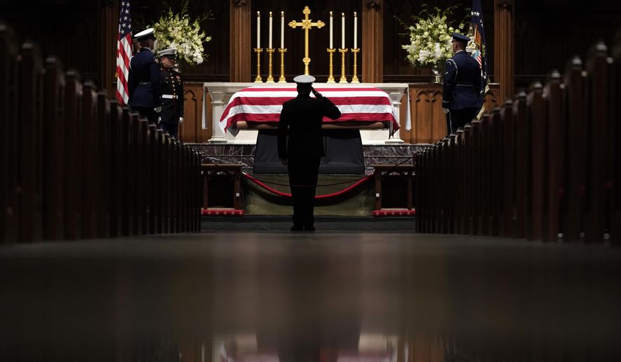 People pay their respects as the flag-draped casket of former President George H.W. Bush lies in repose at St. Martin's Episcopal Church Wednesday, Dec. 5, 2018, in Houston. (AP Photo/David J. Phillip, Pool)
