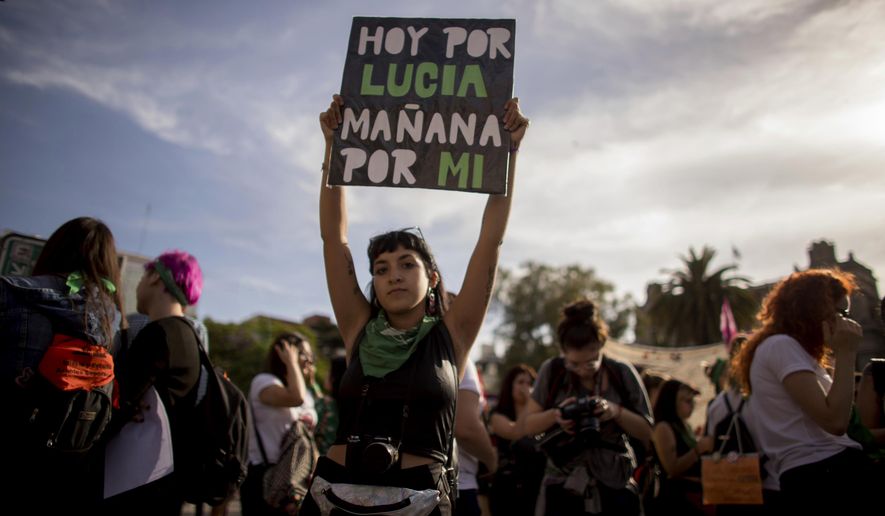 A woman holds up a sign that reads in Spanish: "Today for Lucia. Tomorrow for me," referring to gender violence victim Lucia Perez, during a protest against gender violence in Buenos Aires, Argentina, Wednesday, Dec. 5, 2018. Argentine feminist groups and labor unions are protesting a court ruling that acquitted two men accused of sexually abusing and killing the 16-year-old girl. (AP Photo/Tomas F. Cuesta)