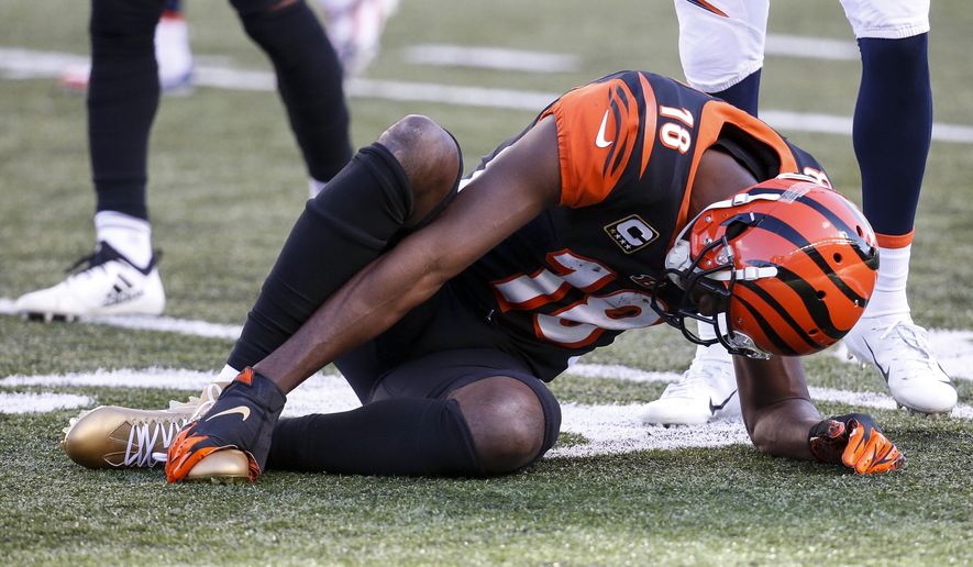 FILE - In this Sunday, Dec. 2, 2018, file photo, Cincinnati Bengals wide receiver A.J. Green (18) reacts after an apparent injury in the first half of an NFL football game against the Denver Broncos in Cincinnati. The Bengals face the Chargers on Sunday. (AP Photo/Frank Victores, File)