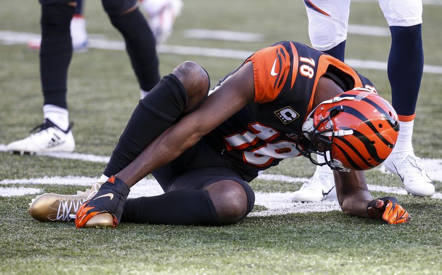 FILE - In this Sunday, Dec. 2, 2018, file photo, Cincinnati Bengals wide receiver A.J. Green (18) reacts after an apparent injury in the first half of an NFL football game against the Denver Broncos in Cincinnati. The Bengals face the Chargers on Sunday. (AP Photo/Frank Victores, File)